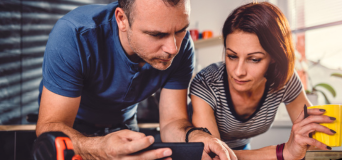 Tradie business owners reviewing their job on their devices